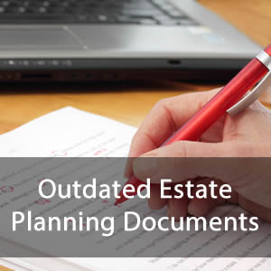 Outdated Estate Planning Documents - A person writing something with a red pen